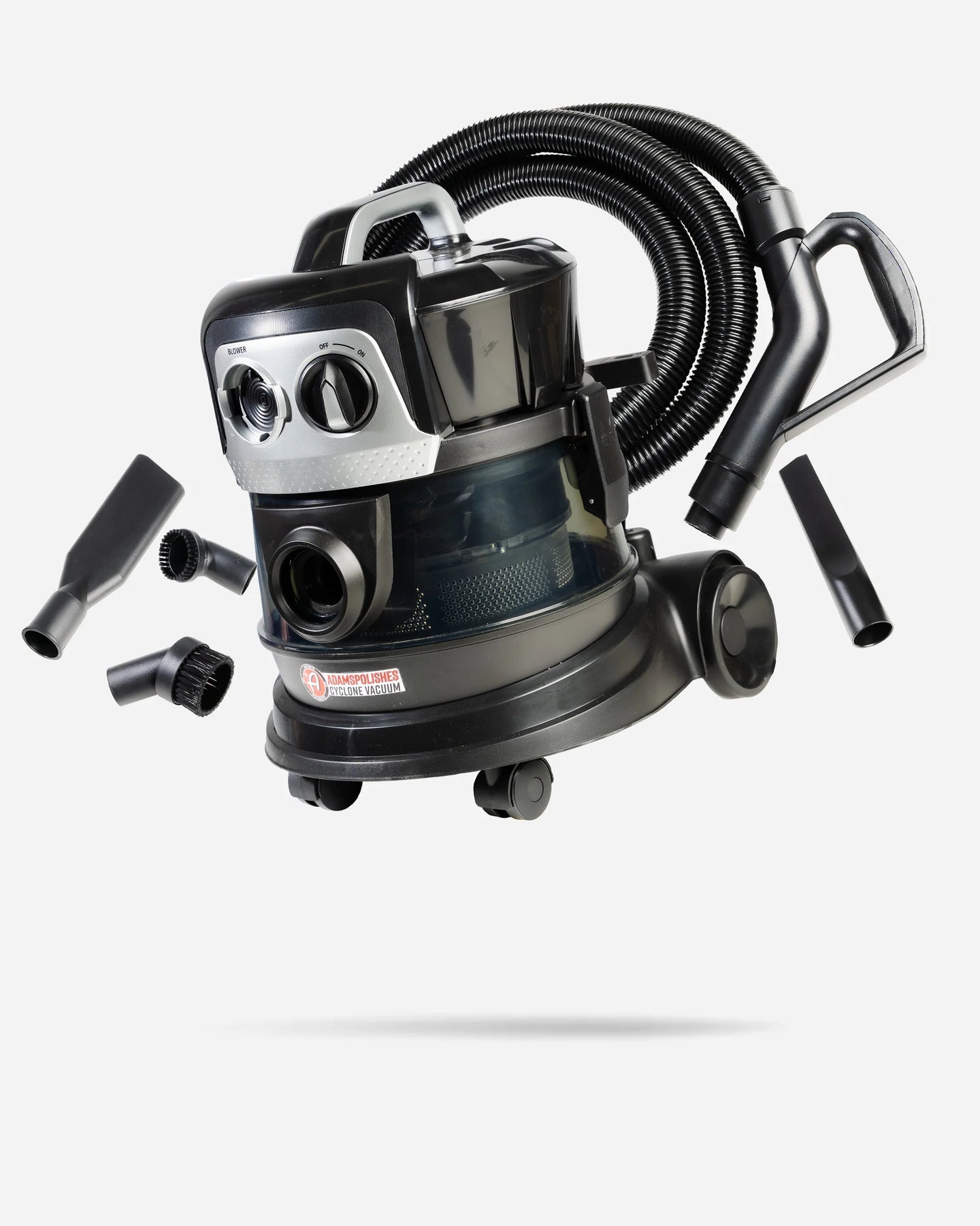A black and silver wet/dry vacuum cleaner with a flexible hose, shown floating against a light gray background with several black attachment nozzles arranged around it.