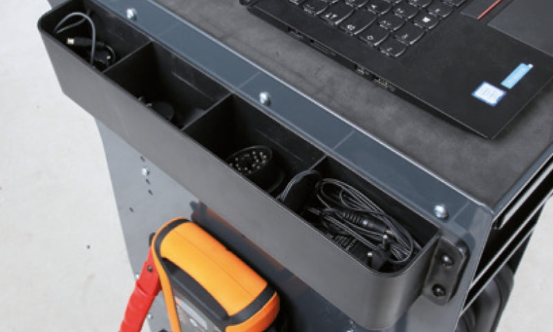 Tool chest with a laptop and tools inside, on a light gray background
