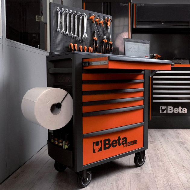 Orange tool cart with tools and equipment in a workshop setting, featuring the Beta brand.