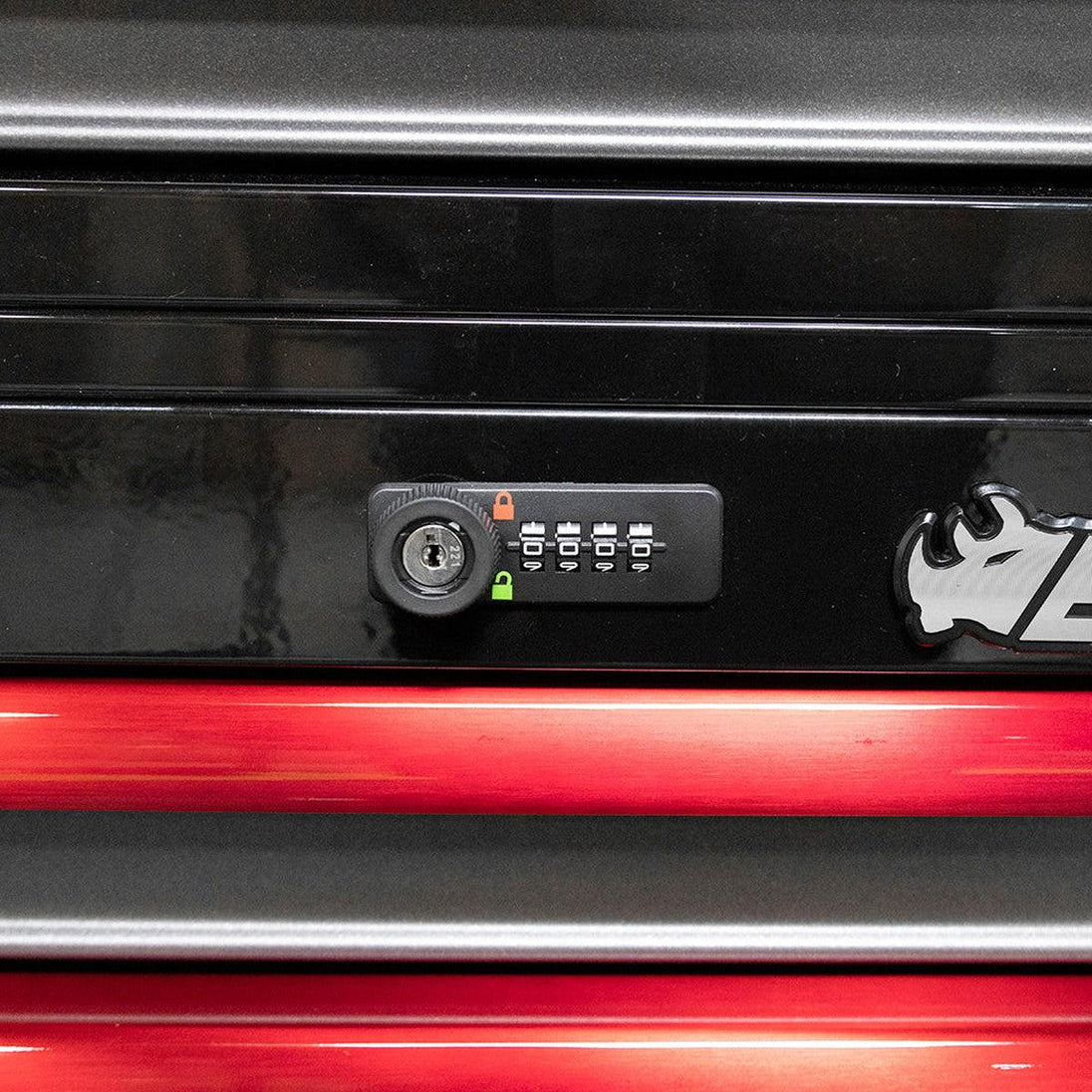 Close-up of a black and red cabinet with a lock mechanism and logo.