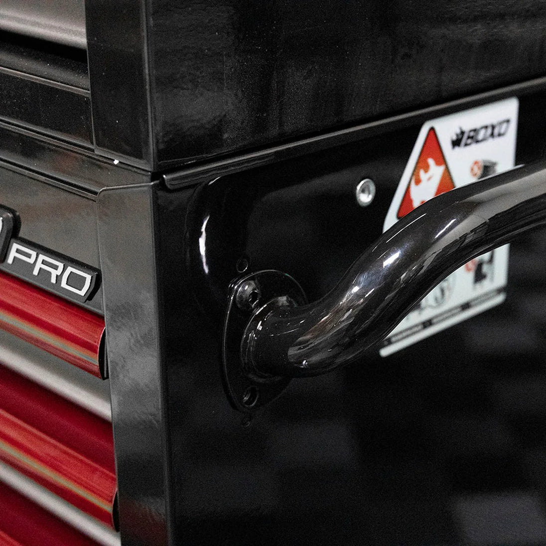 Close-up of a black cabinet door with a handle and 'Pro' branding.
