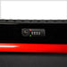 Close-up of a red and black suitcase with a lock and digital display on a white background