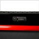 Close-up of a red and black suitcase with a lock and digital display on a white background