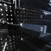 Close-up of a power strip with multiple outlets on a reflective black surface
