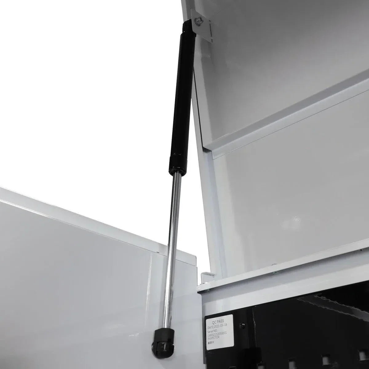 Close-up of a white cabinet with a black support rod on a white background