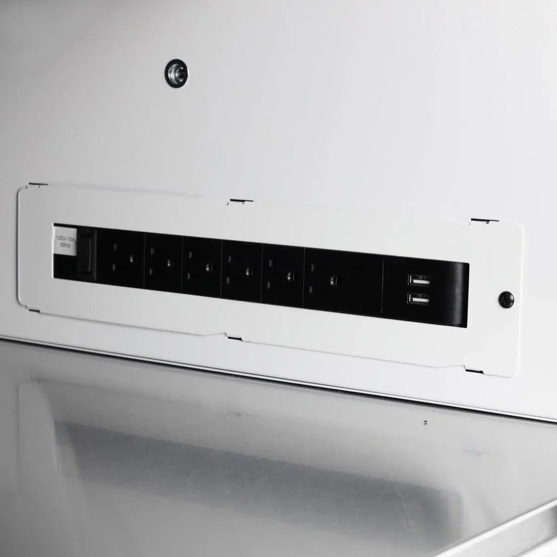 Close-up of a white electronic device with black control panel