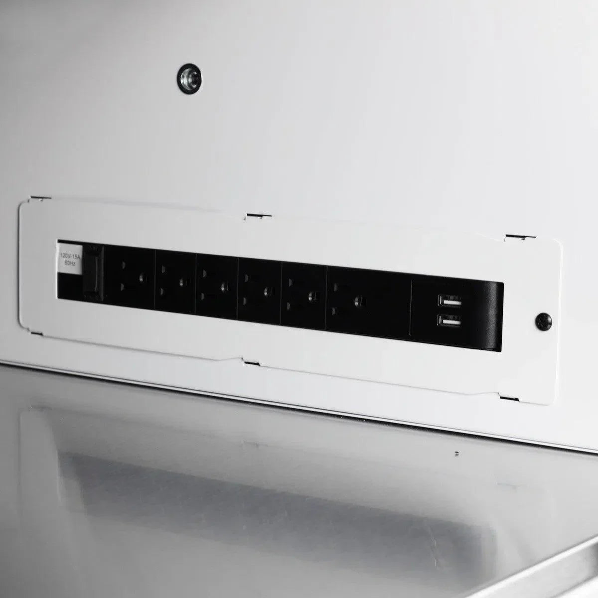 Close-up of a white electronic device with black control panel