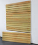 pvc slatwall panel with horizontal slats on a white wall