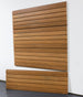 Wooden slatwall panel design on a white wall