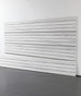 White wooden slatwall panel against a white wall