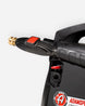 Close-up of an Adams pressure washer nozzle with a brass tip and red switch, attached to a black wand, on a light gray background.
