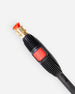 Close-up of a high-pressure water spray gun nozzle with a black ribbed handle, a red power button, a brass connector, and an orange-red trigger tip, shown on a light gray background.