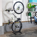 Bicycle on a stand in a garage with tools and equipment in the background