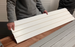 a man holding slatwall panel